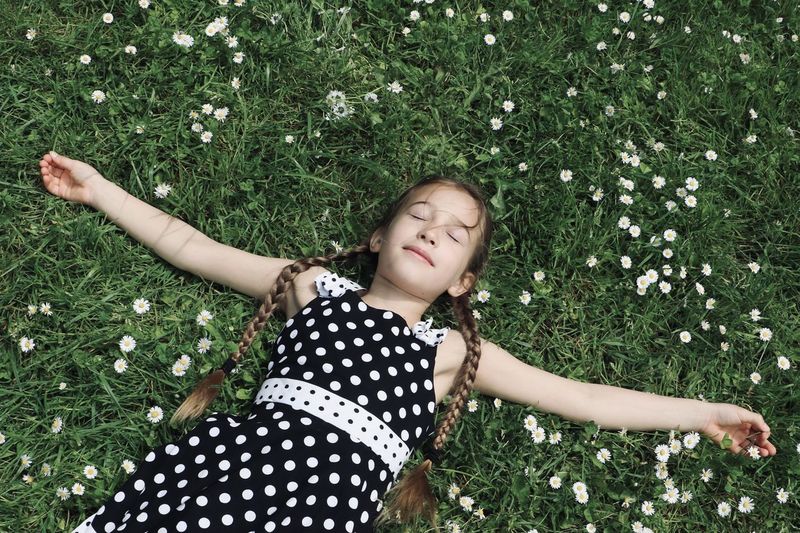 Portrait of young woman standing against plants