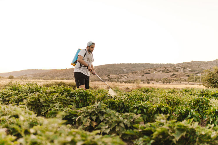 Man spraying pesticides on farm