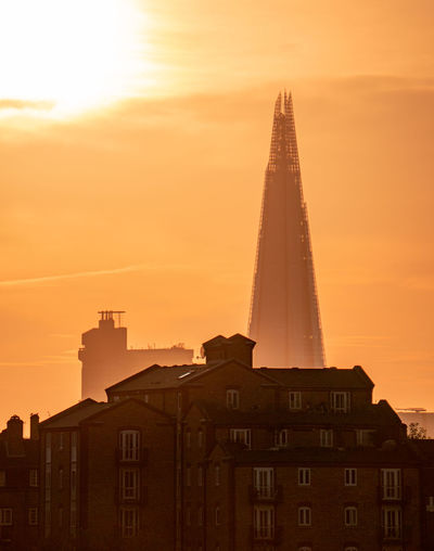 Low angle view of buildings against sky during sunset london the shard
