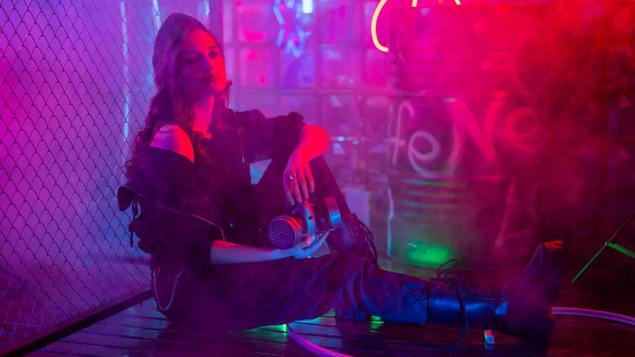 Young woman sitting at nightclub