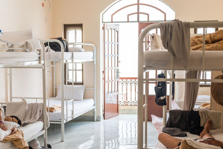 Men sleeping bunkbeds in hostel