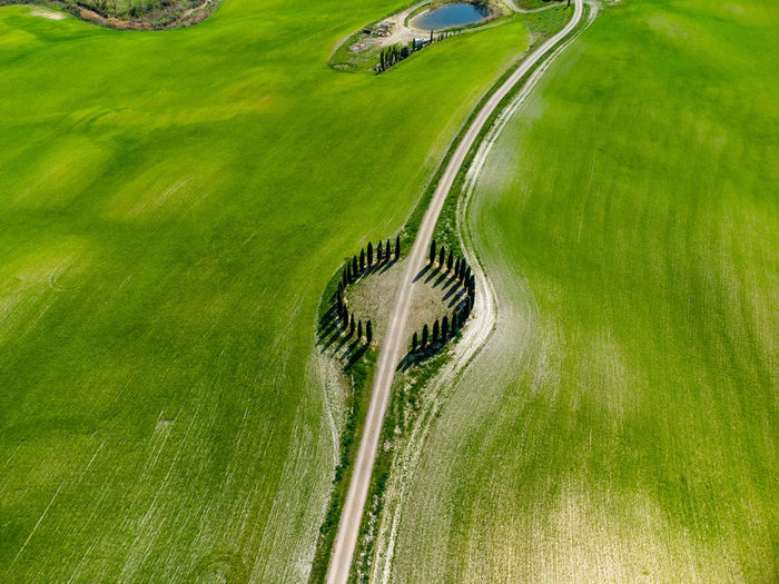 High angle view of road amidst green field