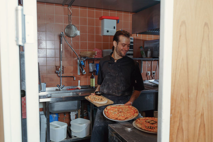 Portrait of man working in kitchen