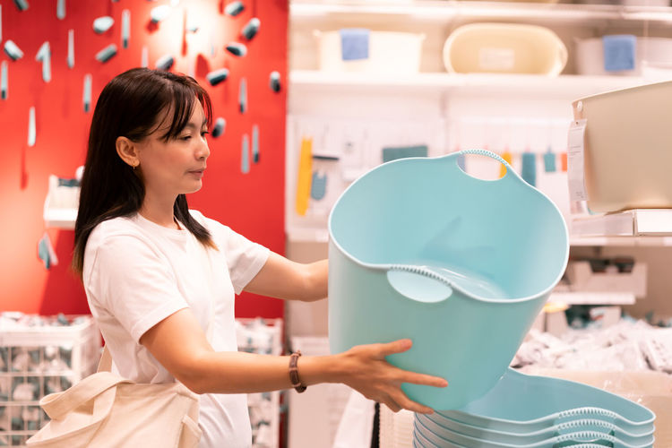 Asian woman shopping furniture for decorate home