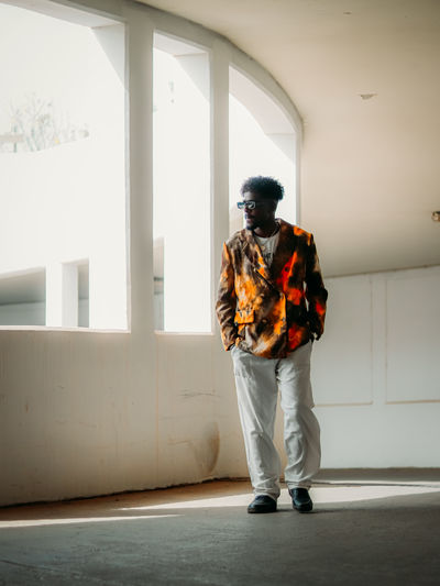 Rear view of man standing against wall