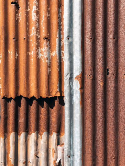 Old and rusty zinc sheet wall. vintage style metal sheet roof texture. pattern of old metal sheet. 