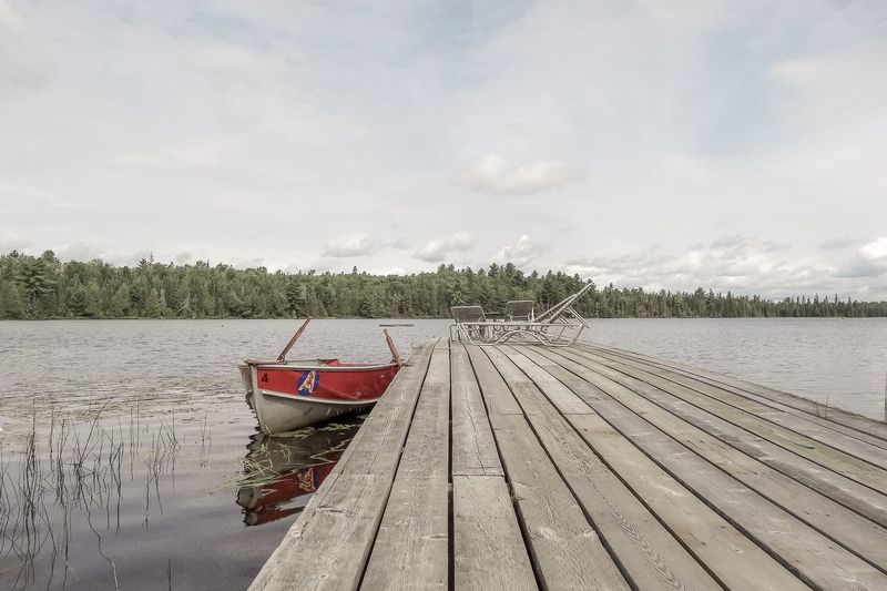 Pier over lake against sky