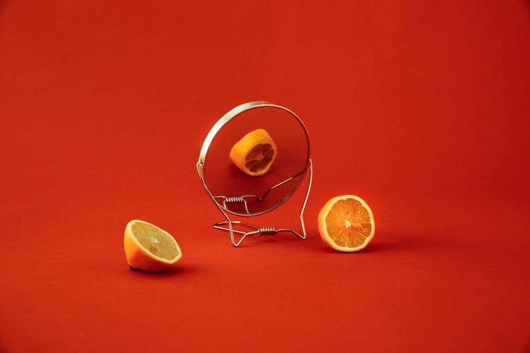 Studio shot of drink against orange background
