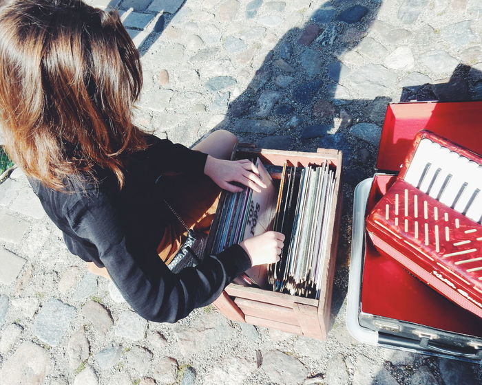 High angle view of woman choosing vinyl records at market