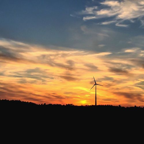 Silhouette of windmill at sunset