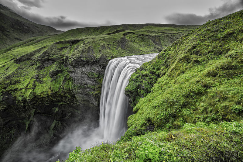 Scenic view of waterfall against sky