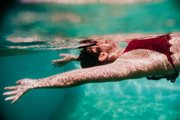 Mid adult woman swimming in pool