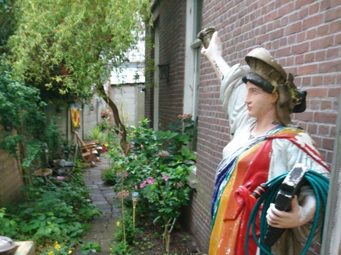 Girl standing by plants in yard
