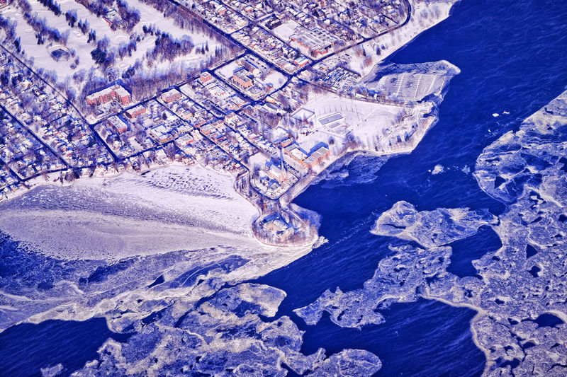 Aerial view of river and cityscape during winter