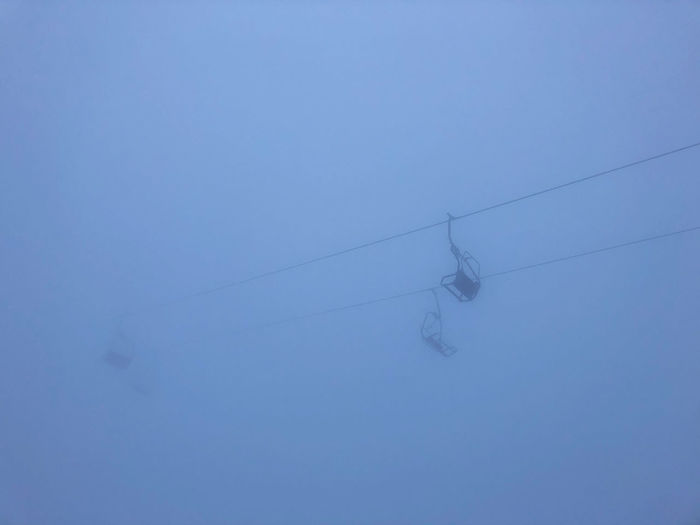 Low angle view of power line against clear blue sky