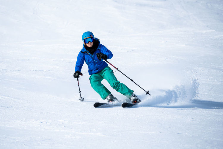 Full length of woman skiing on snow