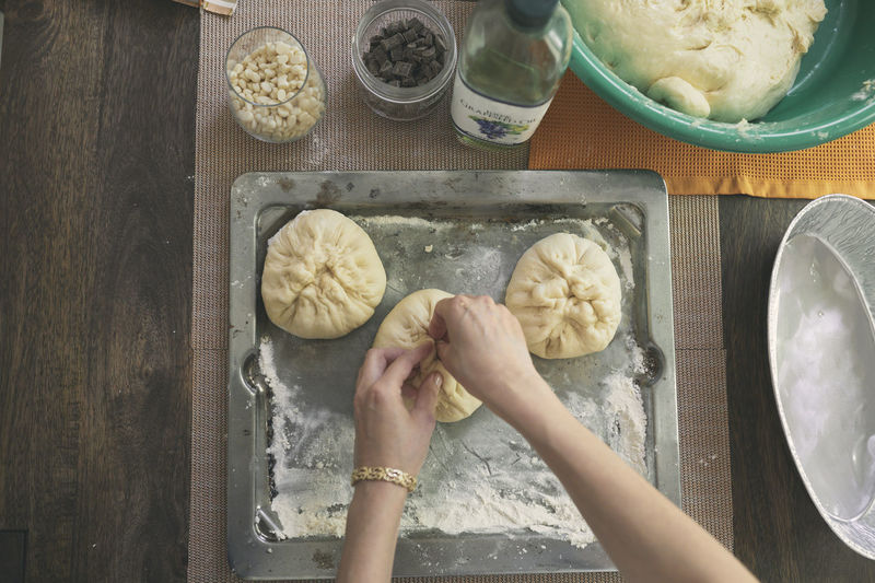 Cropped image of hands kneading dough for challah bread at table