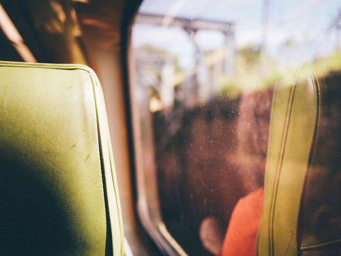 Close-up train seat by glass window