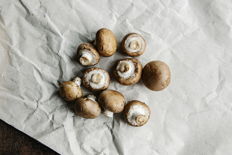Arranged brown mushrooms on craft paper