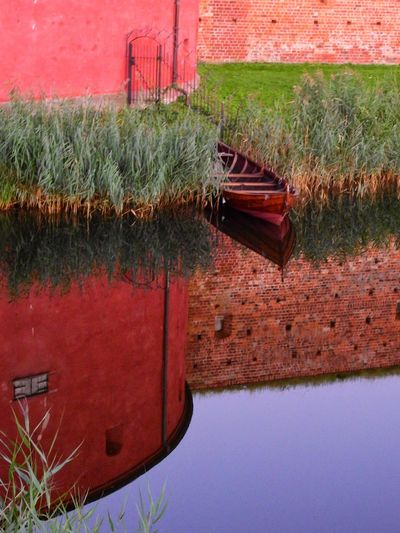 Boat on grass by water