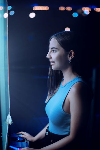 Young woman looking at illuminated lights