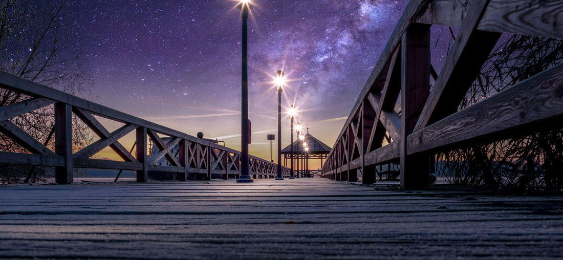 View of bridge over street at night
