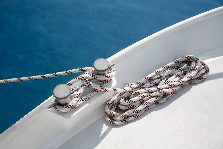 High angle view of rope tied to railing