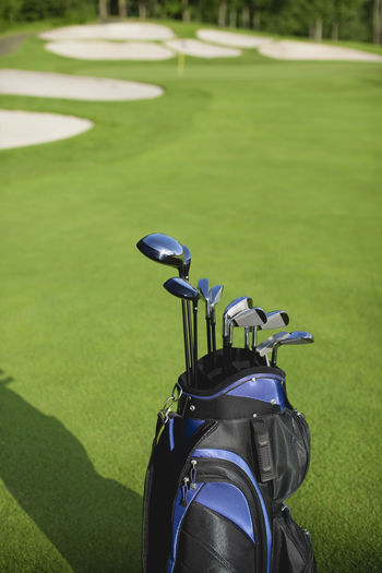Golf clubs in bag on sunny golf course