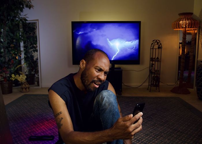 Man using mobile phone at home