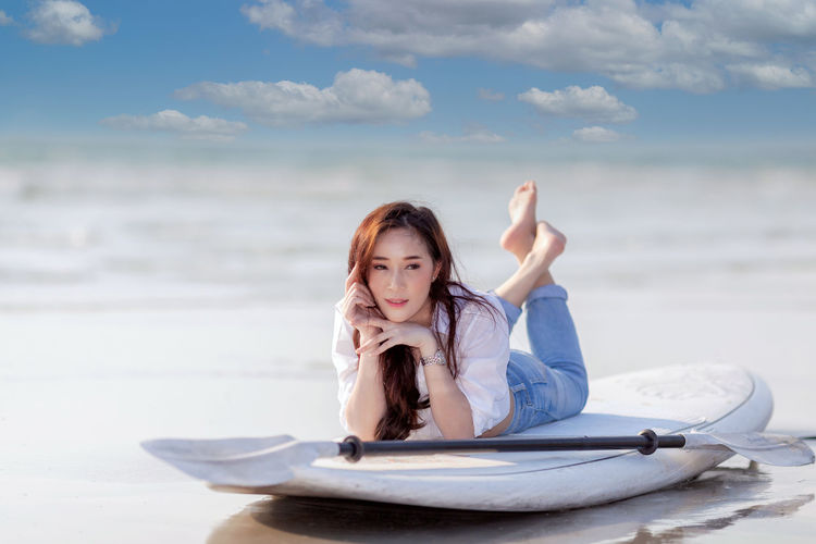 Portrait of young woman sitting on beach