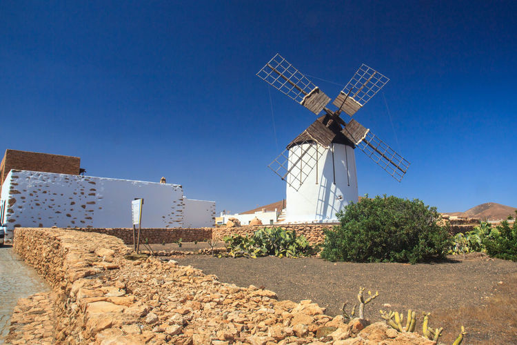 Traditional windmill against clear blue sky