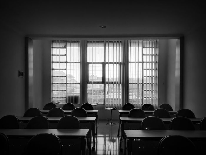 Empty chairs and table in room