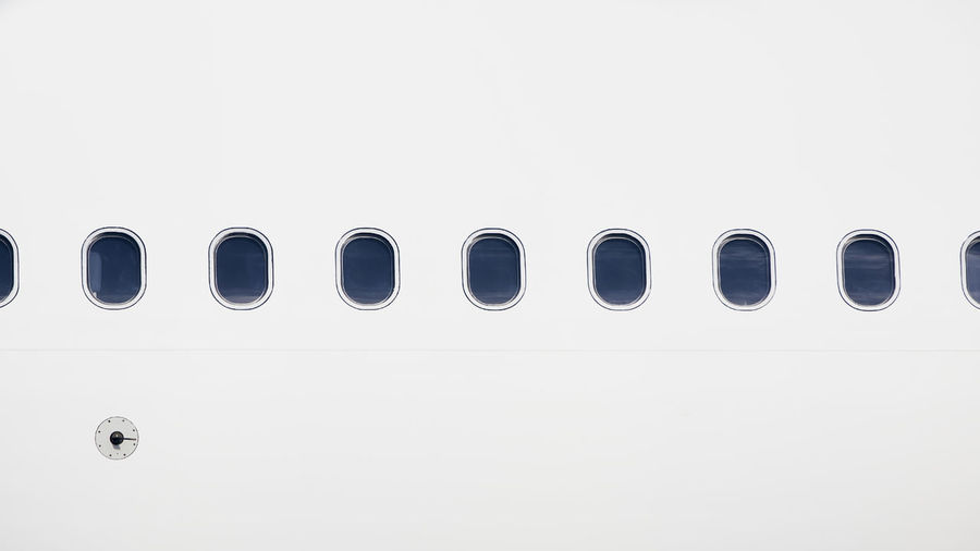 Windows on fuselage of airplane. white plane with copy space.