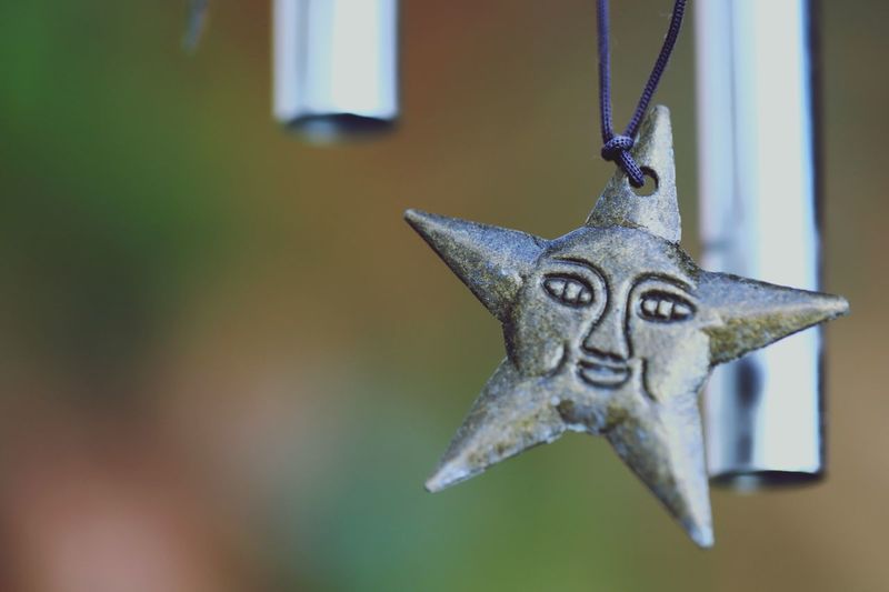 Close-up of star hanging on metal