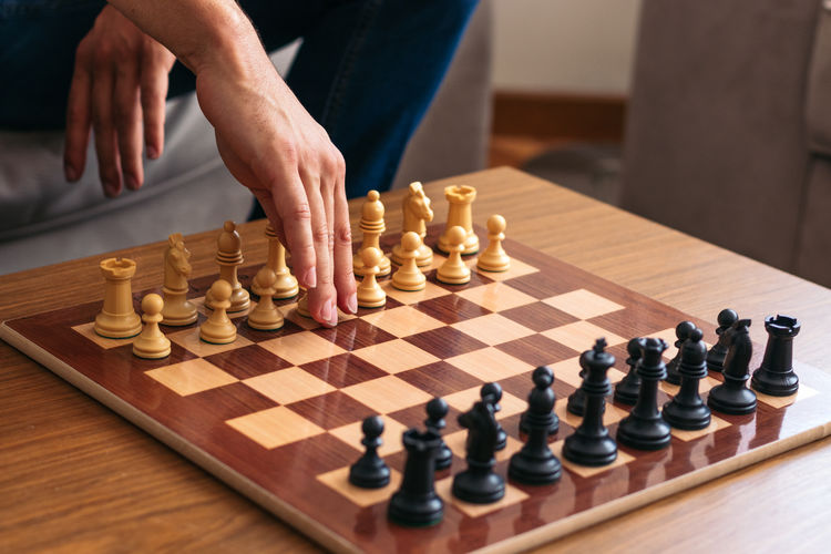 Midsection of man playing chess