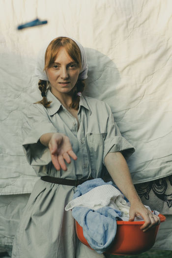 Portrait of woman holding a bed