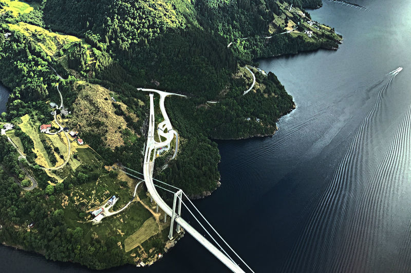 High angle view of bridge over sea by mountain