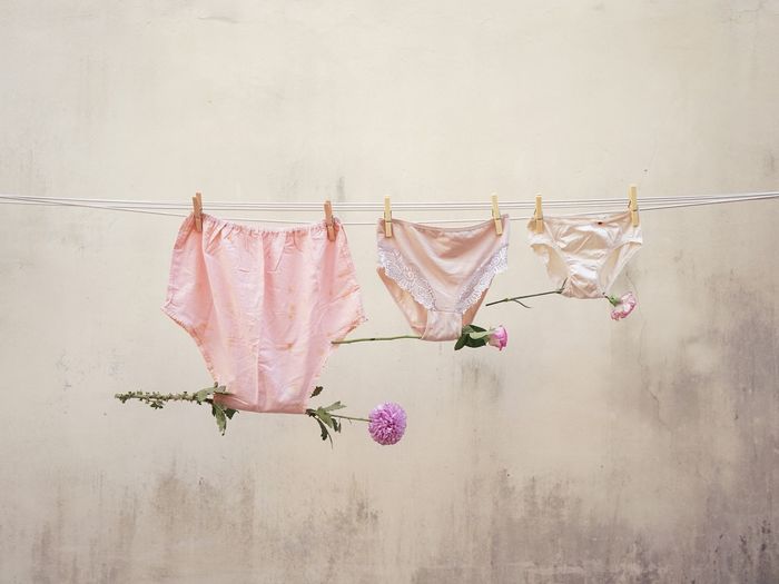 CLOTHES DRYING ON WHITE WALL