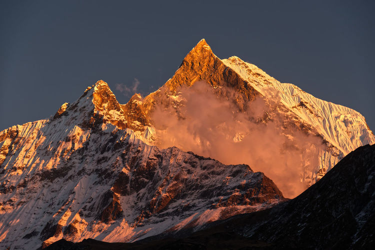 Scenic view of machhapuchhre  mountain against sky at sunset