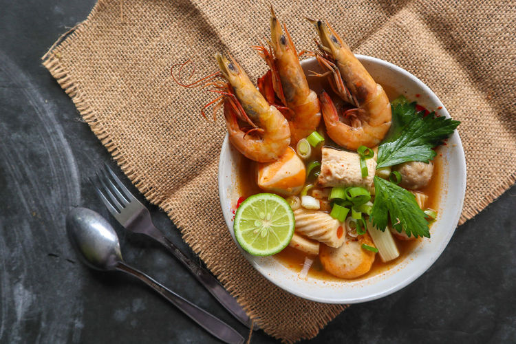 Tom yam soup originating from thailand. tom yum is made with shrimp, chili, lime, chicken, fish,
