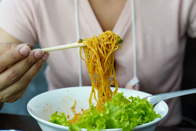 Close-up of person holding food in bowl