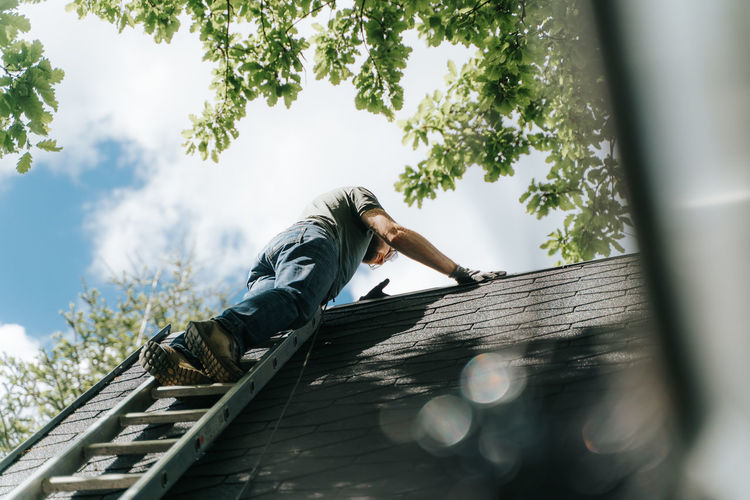 Low angle view of man against built structure