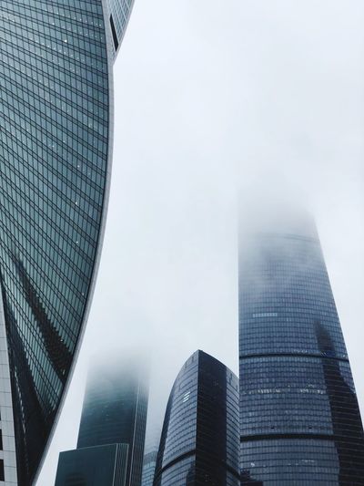 LOW ANGLE VIEW OF BUILDINGS IN CITY AGAINST SKY