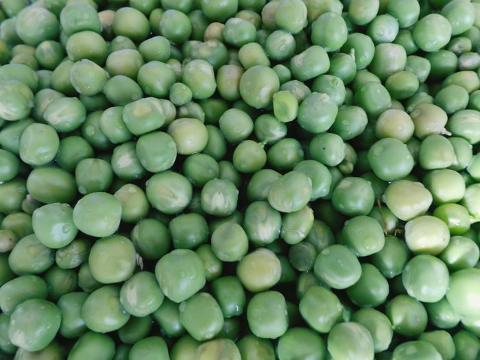 Full frame shot of wet green peas
