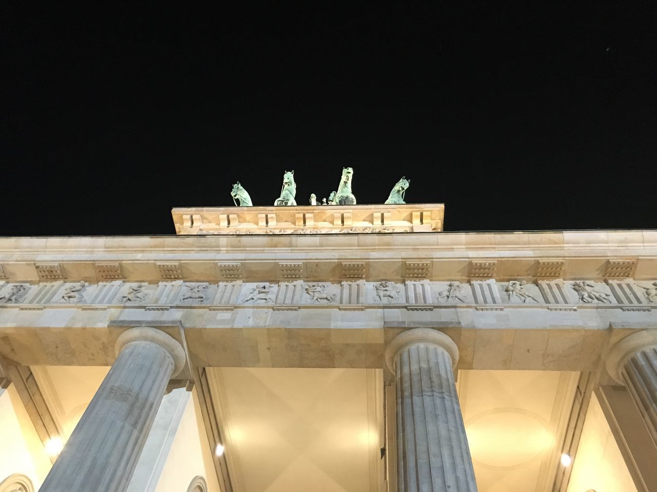 Low angle view of illuminated brandenburg gate against clear sky at night