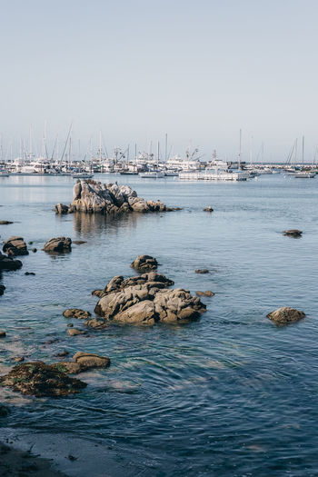 Sailboats in sea against clear sky
