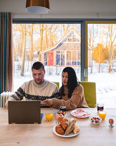 Young couple sitting on table