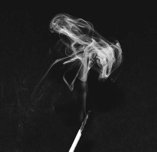 Close-up of smoke emitting from black background