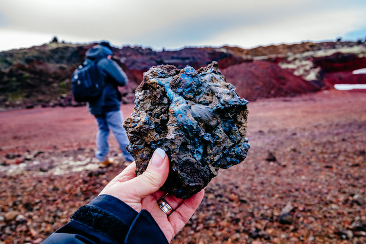 Cropped image of woman holding volcanic rock