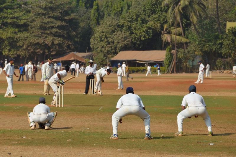 Group of people playing cricket at oval maidan in mumbai